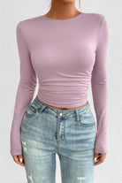 VacationGrabs open back long sleeve top in soft lavender paired with distressed jeans for a trendy look