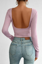 Stylish open back long sleeve top in lavender with a fitted design and deep back cutout