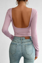 Stylish open back long sleeve top in lavender with a fitted design and deep back cutout