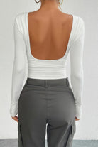 White open back long sleeve top with a sleek design, perfect for stylish outings