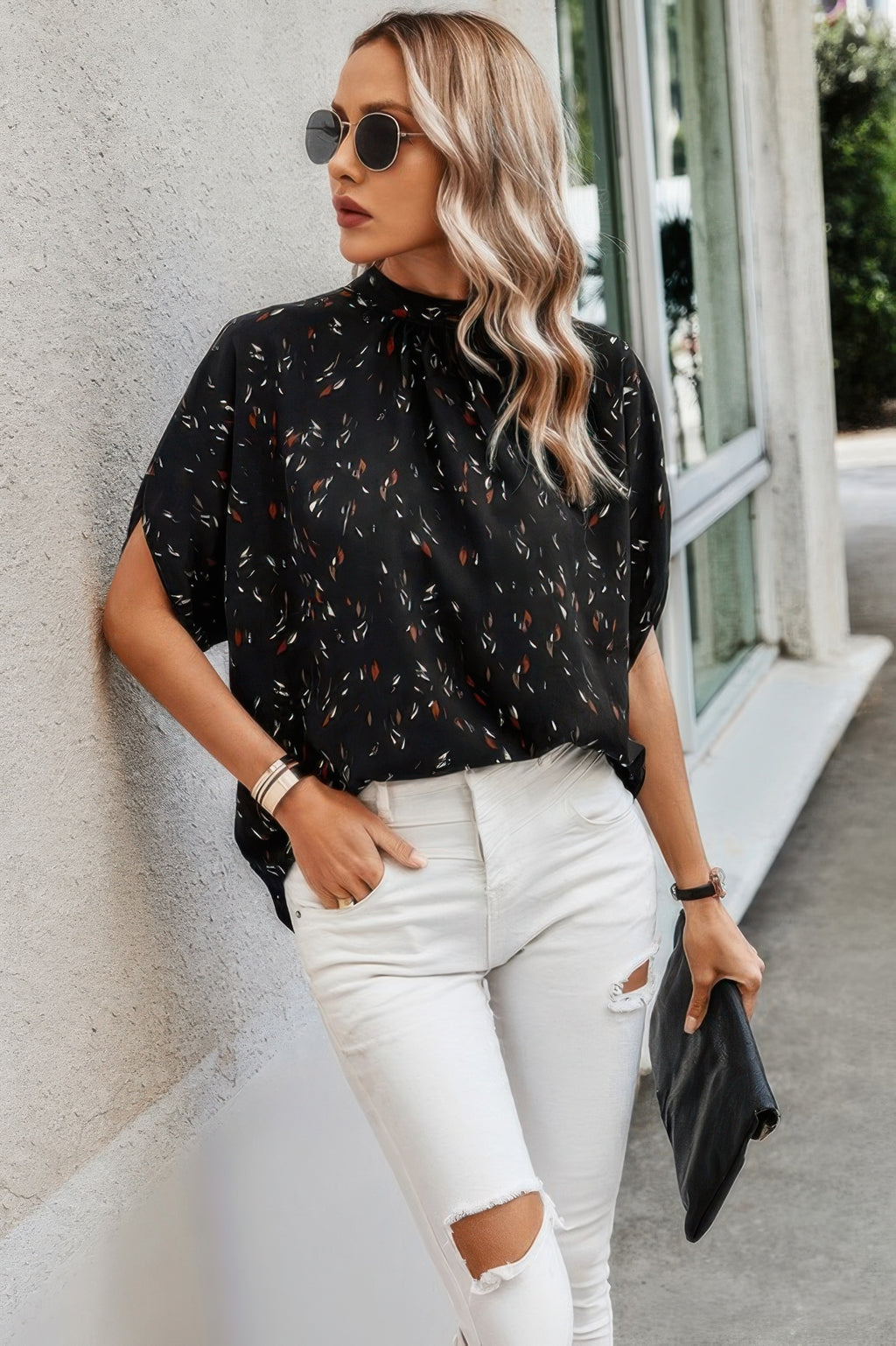 Stylish black open back summer tops for women with colorful patterns paired with white ripped jeans