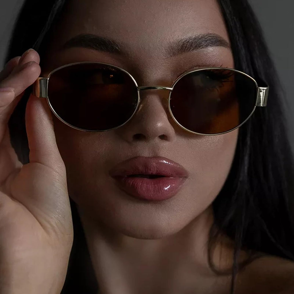 Women's gold-framed oval sunglasses for stylish sun protection