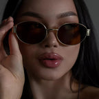 Women's gold-framed oval sunglasses for stylish sun protection