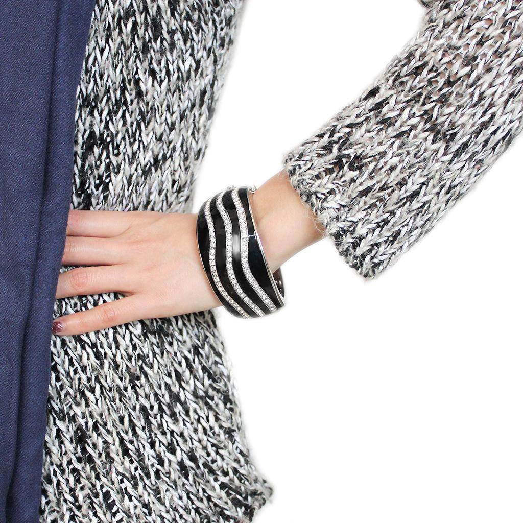 Stylish woman wearing an oversized black crystal bangle on her wrist with a fashionable outfit