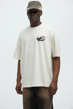 VacationGrabs oversized graphic tee for men in light beige with small chest logo and relaxed fit