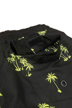 Close-up of WEIV men's swimwear featuring palm tree print swim shorts with vibrant yellow design
