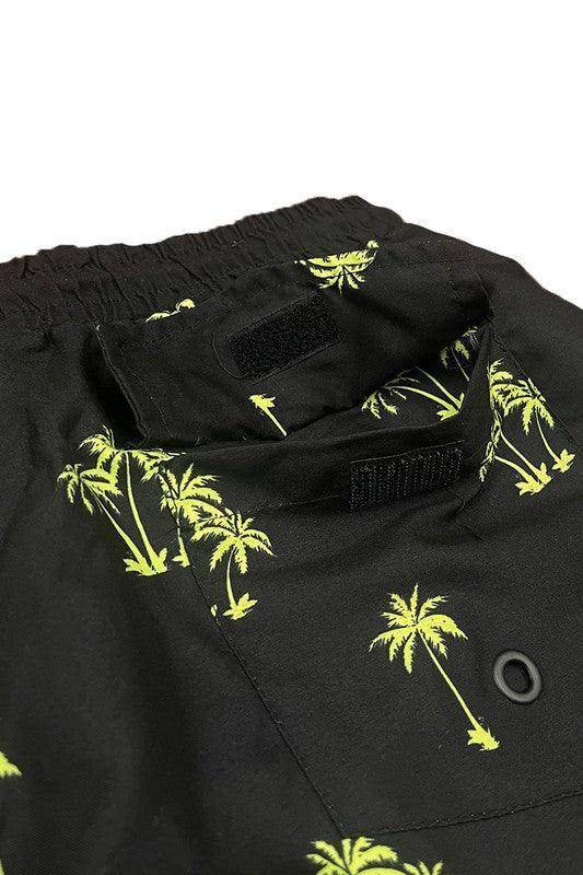 Close-up of WEIV men's swimwear featuring palm tree print swim shorts with vibrant yellow design