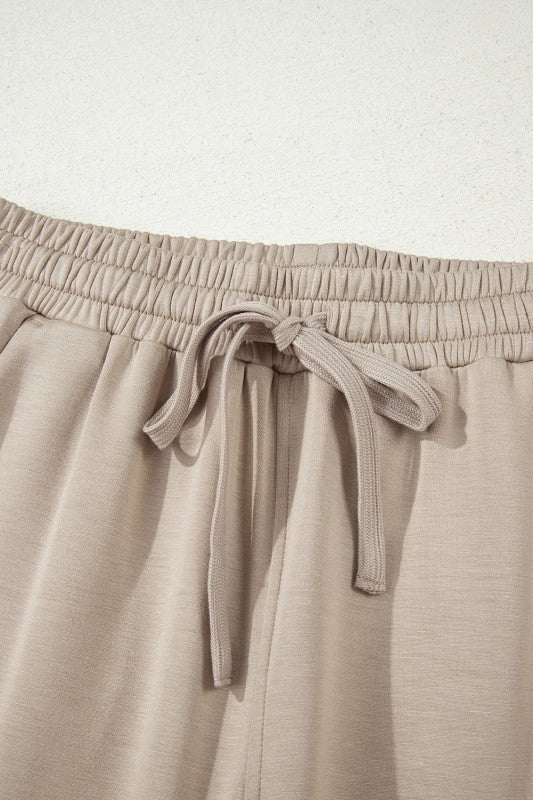 Women's activewear pants and bra set in beige, perfect for workouts