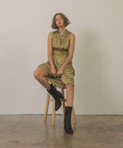 Chic Oasis Society Paris style boots for women paired with a stylish green dress on a stool