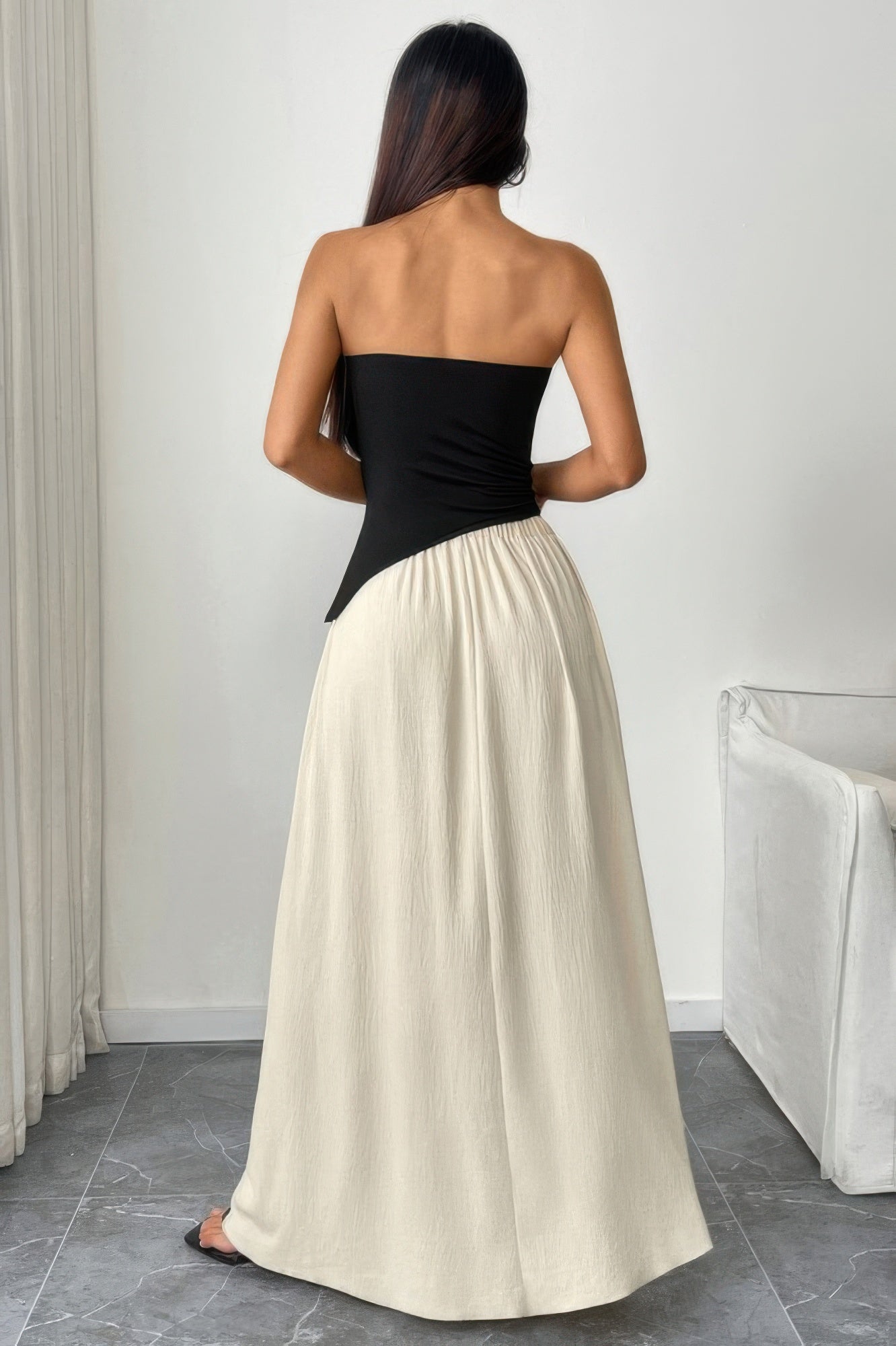 Back view of a patchwork strapless tube dress by VacationGrabs with a sleek design and flowing skirt