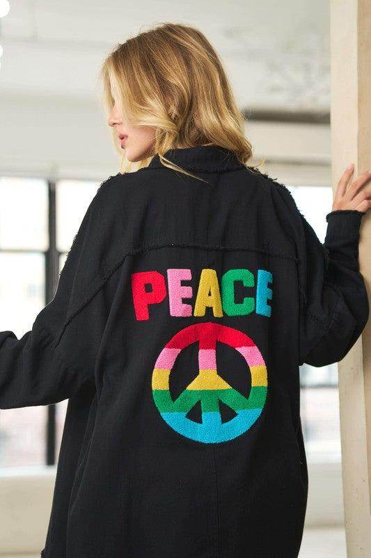Davi & Dani women's peace symbol vacation shirt in black featuring colorful peace emblem on the back