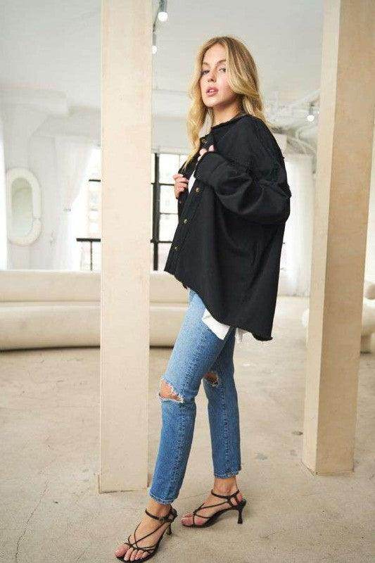 Davi & Dani women's peace symbol vacation shirt in black, styled with ripped jeans for a trendy look.