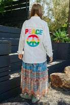 Davi & Dani women's vacation shirt featuring a colorful peace symbol design on the back
