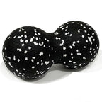 Black peanut massage ball for muscle relaxation, textured surface