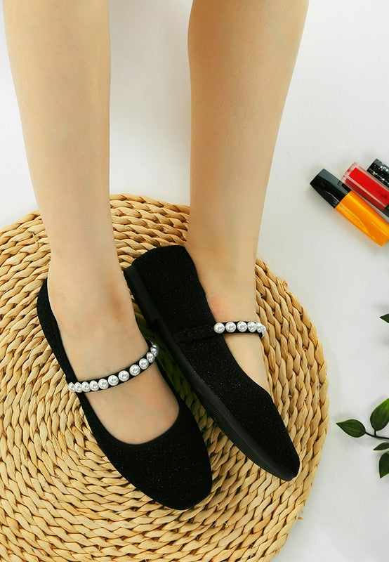 Rag Company women's black pearl detail Mary Jane flats on feet over woven mat