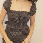 Women's black polka dot peplum top, perfect for casual outings