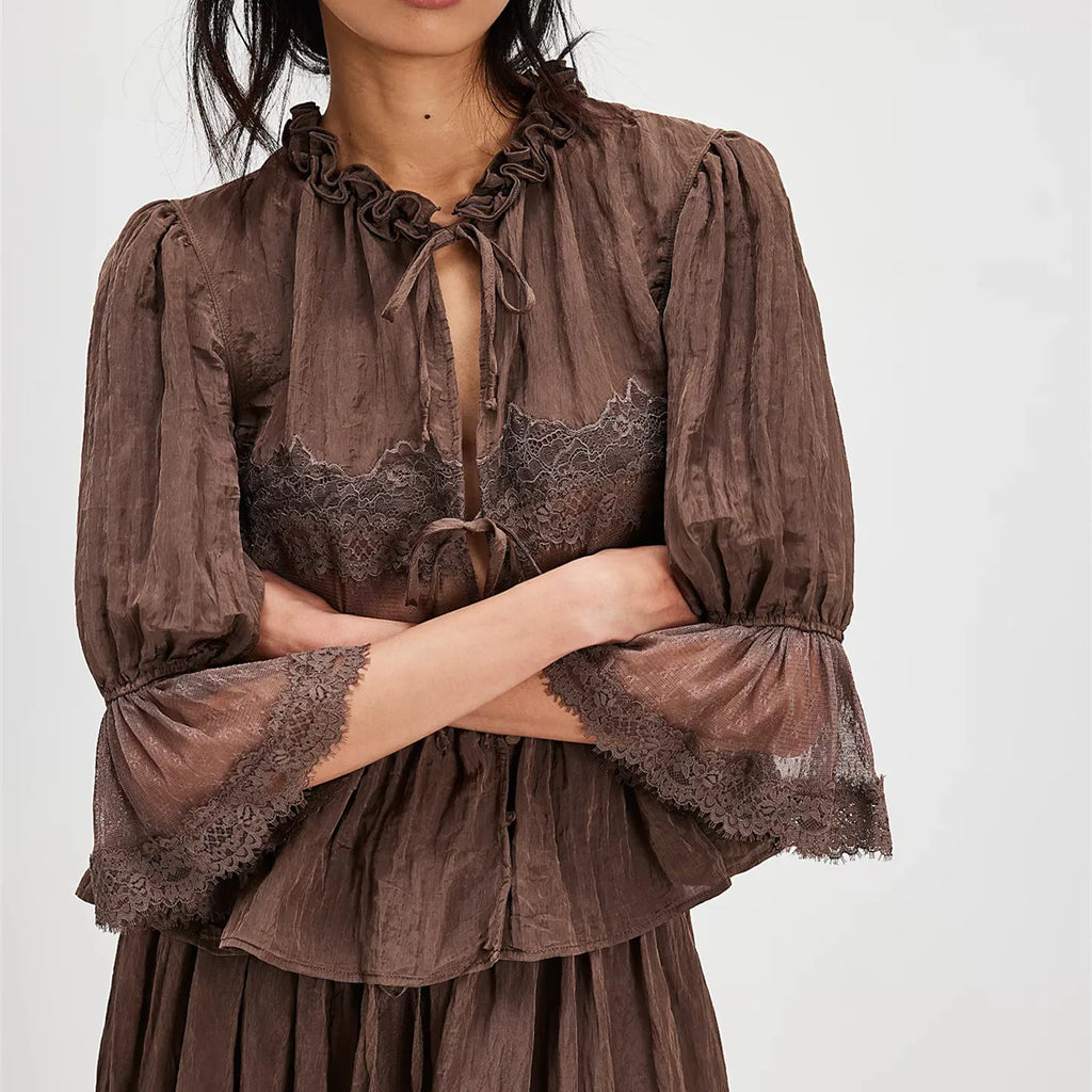 Women's brown peplum top with lace trim, perfect for casual outings