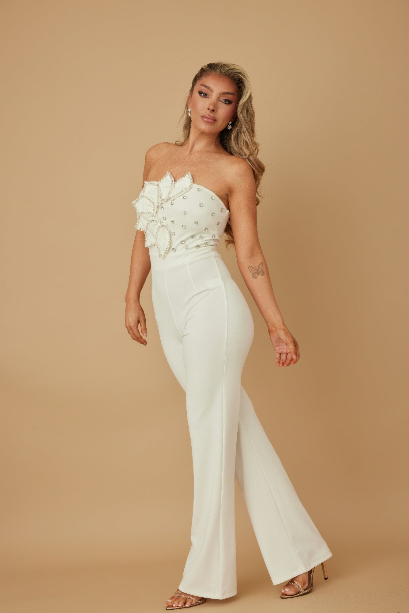 Stylish women’s petal rhinestone jumpsuit in white with floral detail, perfect for special occasions