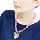 Stylish pink beaded heart pendant necklace perfect for casual and elegant occasions.