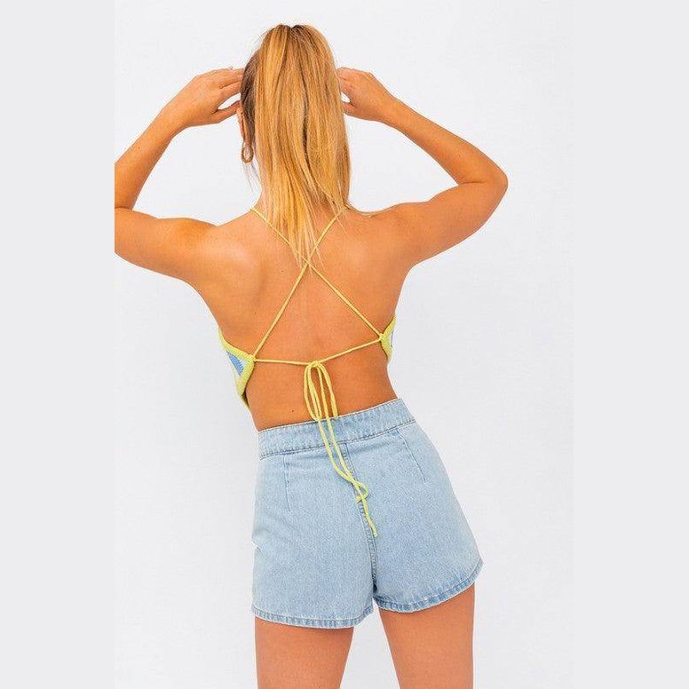 Back view of LE LIS pink blue multi crop top with adjustable straps, styled with denim shorts