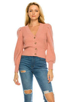Pink cardigan for women with a v-neck and puff sleeves, styled with ripped jeans