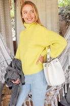 Lumiere pink cozy fall sweater paired with light jeans and a white handbag, ideal for autumn fashion