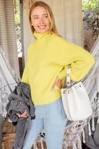 Lumiere pink cozy fall sweater paired with light jeans and a white handbag, ideal for autumn fashion