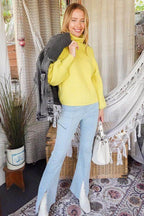 Vibrant yellow women's sweater styled with light blue jeans, perfect for autumn outfits and layering