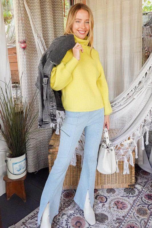 Vibrant yellow women's sweater styled with light blue jeans, perfect for autumn outfits and layering