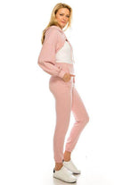 Stylish pink crop top and bottom set from Andante USA featuring a comfortable hoodie and jogger pants