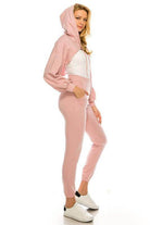 Stylish women's pink crop top and bottom set with a hoodie and jogger pants for casual wear