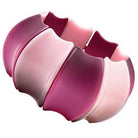 Pink resin statement bracelet featuring a unique wavy design perfect for trendy women's jewelry.