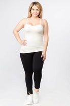 Women modeling a pink seamless tank top paired with black leggings for a chic and comfortable look