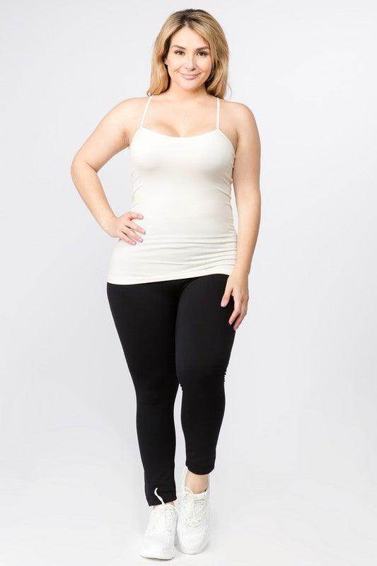 Women modeling a pink seamless tank top paired with black leggings for a chic and comfortable look