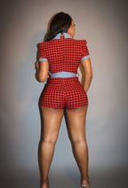 Back view of a stylish plaid denim romper for women with puff sleeves and a fitted design
