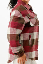 Plaid flannel shacket for women in red, brown, and white with button details and side pockets