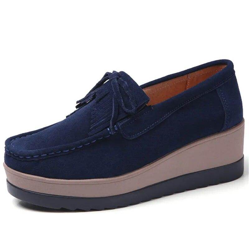 Navy platform slip-ons for travel featuring a comfortable design and stylish fringe detailing