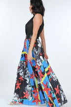 VacationGrabs pleated print maxi skirt with vibrant red starfish and floral patterns on a flowing fabric