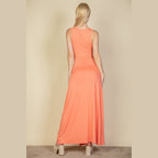 Capella women's plunge neck thigh split dress in coral shown from the back with sleeveless design