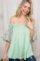 Light green plus size off shoulder top with animal print sleeves for a stylish summer look