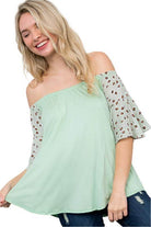 Plus size off shoulder top in soft mint green with leopard print sleeves for a stylish look