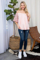 e Luna plus size off shoulder top in light pink with flutter sleeves and a relaxed fit