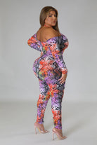 Plus size snake print jumpsuit with vibrant colors and off-shoulder design by VacationGrabs