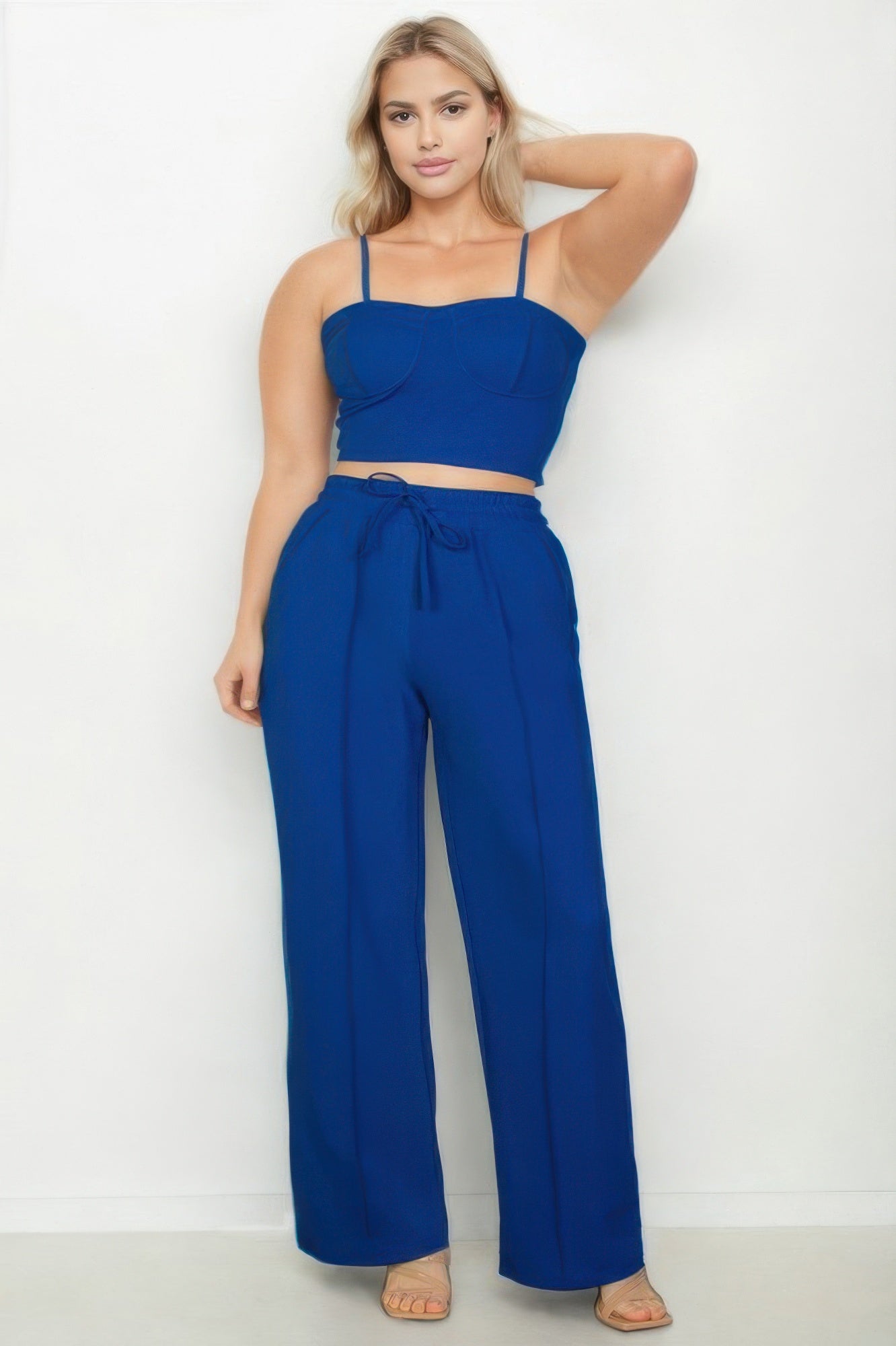 Plus size vacation outfits for women featuring a stylish blue crop top and wide-leg pants