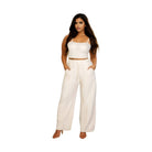 Stylish plus size vacation outfits for women featuring a chic crop top and wide-leg pants in white