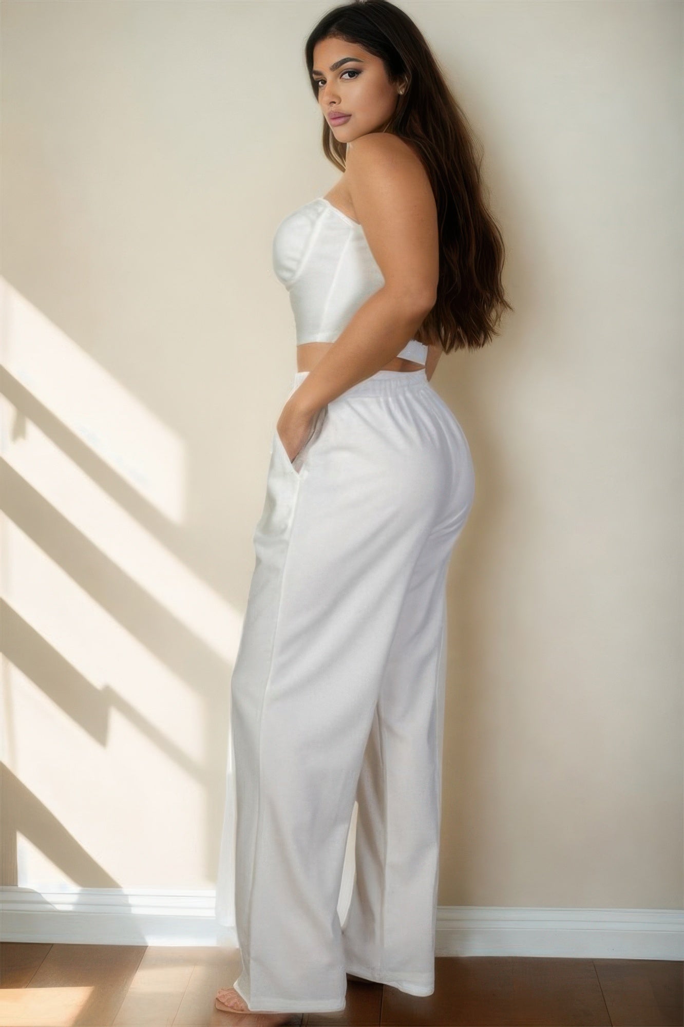 Stylish plus size vacation outfits for women featuring a strapless top and wide-leg pants in white