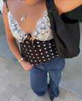 Women's black polka dot top with lace details for casual outings