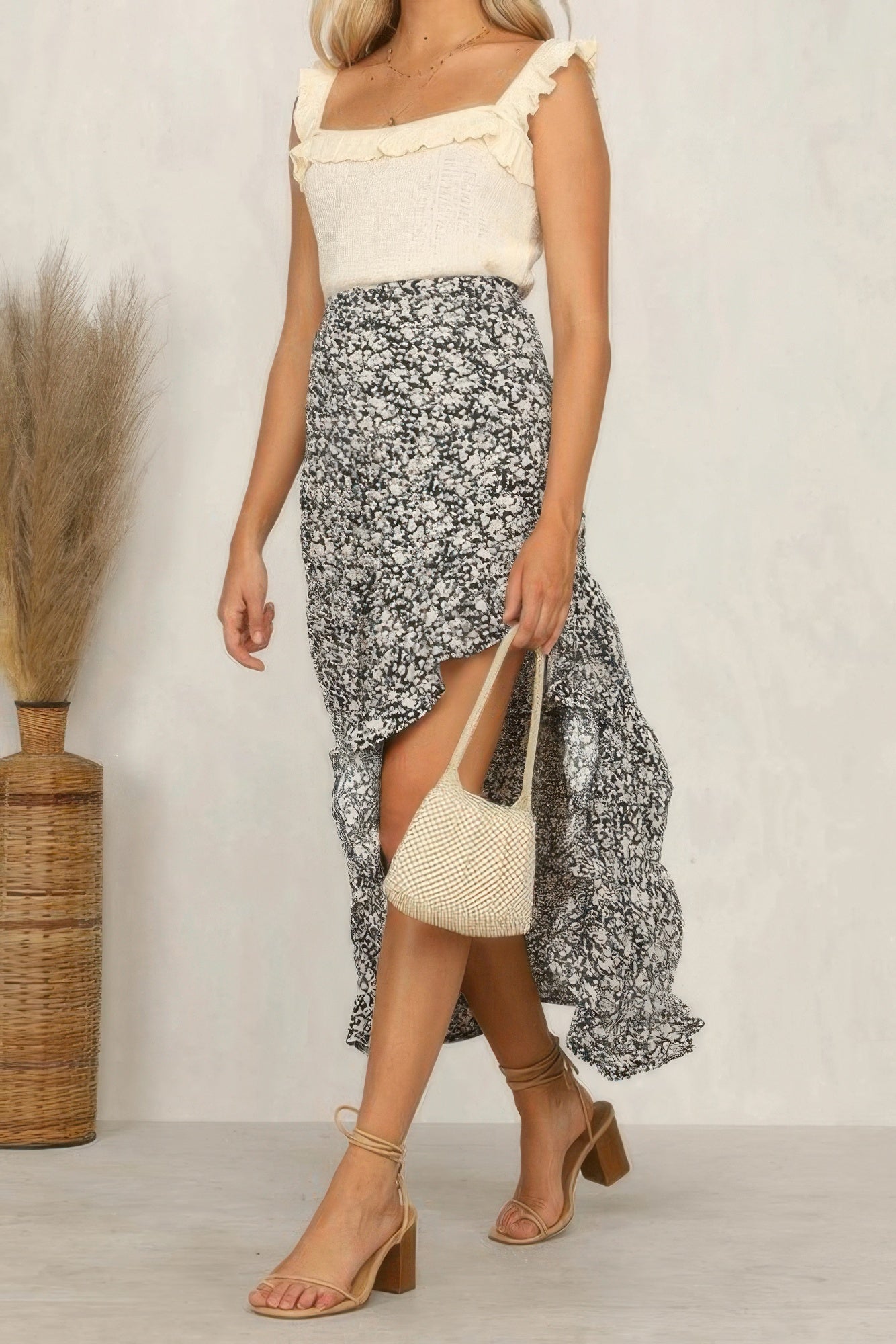 Stylish woman wearing a polka dot ruffled maxi skirt paired with a ruffled top and sandals