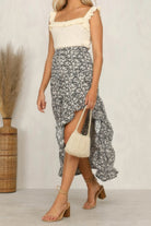Stylish woman wearing a polka dot ruffled maxi skirt paired with a ruffled top and sandals