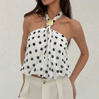 Women's white polka dot top with halter neckline, perfect for casual outings